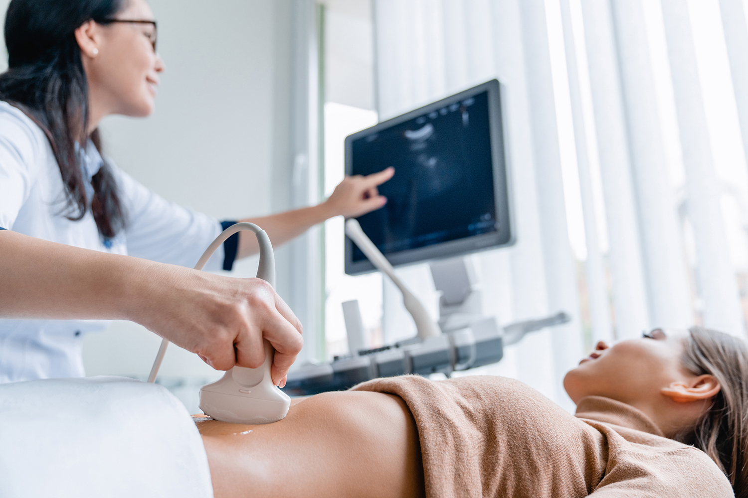 pregnant woman in hospital having scan with doctor